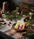 Slice of biscuit sponge cake with white cream and cherry sauce inside on copper vintage plate Royalty Free Stock Photo