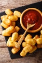 Homemade tater tots with tomato sauce close up. Vertical top vie