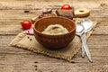 Homemade Thanksgiving garlic mashed potatoes with fresh tomatoes and pastrami. Sackcloth napkin, spoons, old wooden boards Royalty Free Stock Photo