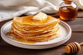 Homemade thin crepes with honey, pancakes on wooden rustic kitchen table