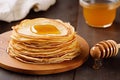 Homemade thin crepes with honey, pancakes on wooden rustic kitchen table