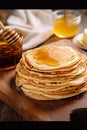 Homemade thin crepes with honey, pancakes on wooden rustic kitchen table