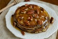 Homemade thin pancakes with honey and pecan nuts on white porcelain plate Royalty Free Stock Photo