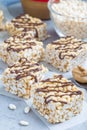 Homemade three ingredients bars: crispy rice, honey and peanut butter vertical