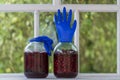 Homemade tincture of red cherry in a jar with a glove shaped shutter. Berry alcoholic drinks concept. Homemade red wine made from Royalty Free Stock Photo