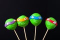 Homemade tiny cakes - cakepops for children`s birthday on a dark