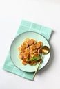 Homemade tiny cereal pancakes on white table. View from above. Copy space