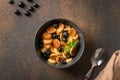 Homemade tiny pancake with blueberry on brown background. View from above. Trendy tasty breakfast