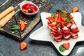 homemade tiramisu cake with fresh strawberry, mascarpone and mint. Tiramisu portion on plate on light background. Delicious no Royalty Free Stock Photo