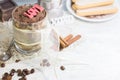 Homemade tiramisu in glass with chocolate, coffee beans and savoyardi biscuits. Copyspace