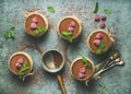 Homemade Tiramisu in individual glasses with frozen raspberries