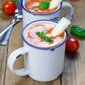 Homemade tomato basil soup in the mug, served with mozzarella cheese stick and croutons, square format Royalty Free Stock Photo