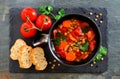 Homemade tomato, lentil soup, flat lay over slate