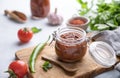 Homemade tomato sauce for pizza or pasta in a jar on a light background with fresh vegetables and herbs close up Royalty Free Stock Photo