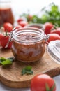 Homemade tomato sauce for pizza or pasta in a jar on a light background with fresh vegetables and herbs close up Royalty Free Stock Photo