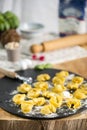 homemade Tortelli Tortellini stuffed over a black stone ardesian tray