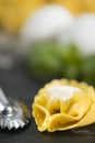 Homemade Tortellini stuffed over a black stone ardesian