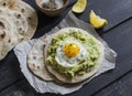 Homemade tortilla with mashed avocado and a fried quail egg.