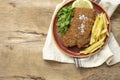 Homemade traditional Milanese veal escalope with french fries