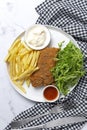 Homemade traditional Milanese veal escalope with french fries