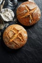 Homemade traditional sourdough loaves of bread on a black background Royalty Free Stock Photo