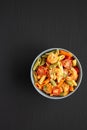 Homemade Tri-Color Penne Salad with Shrimp, Tomato and Basil Bread Crumbs in a Bowl, top view. Flat lay, overhead, from above. Royalty Free Stock Photo