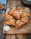 Homemade triangular pies made from ready-made puff pastry with apples