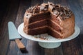 A homemade triple layer low sugar decadent chocolate cake with slices removed.