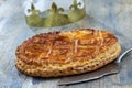 Epiphany Twelfth Night cake french galette des rois made of puff pastry, with the charm inside, open crown leaning on