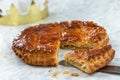 Epiphany Twelfth Night cake french galette des rois made of puff pastry, slice apart with the charm inside, open crown