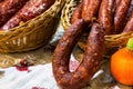 Homemade Ukrainian sausage in baskets on traditional embroidered tablecloth is sale at the market