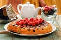 Homemade upside down berry cake served with fresh currants and r