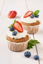 Vanilla cupcakes with cream cheese frosting and fresh berries Royalty Free Stock Photo