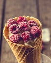 Homemade Vanilla Ice Cream in Waffle Cone with Frozen Raspberry Lying on on Rustic Wooden Background Tasty Ice Cream Summer Royalty Free Stock Photo