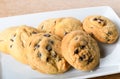 Homemade vanilla, orange, lemon chocolate chip cookies biscuits stack on a white plate