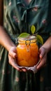 Homemade vegan apricot jam held in gentle hands a jar of pure goodness