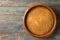 Homemade vegan cake or sourdough bread with carrots bran from spelt dinkel wheat flour in clay baking form on rustic wooden table