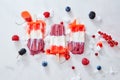 Tricolor strawberry and raspberry ice cream popsicles over ice with berries on marble background, top view and copy Royalty Free Stock Photo