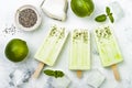 Homemade vegan frozen coconut mojito popsicles - ice pops - paletas with chia seeds.