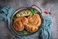 Homemade vegan mini pie with nettle plant in the shape of a snail