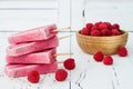 Homemade vegan raspberry coconut milk popsicles - ice pops - paletas with chia seeds on rustic white wooden background.