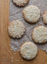 Homemade Vegan Tahini cookies are laid out on a wooden table