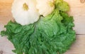 Homemade vegetables. Squash Squash white and lettuce on a wooden background. Green harvest on wooden background. Courgettes on a