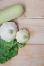 Homemade vegetables. Squash Squash white and lettuce on a wooden background. Green harvest on wooden background. Courgettes on a