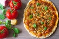 Homemade vegetarian margarita pizza with Parmesan and mozzarella cheese and traditional tomato sauce, topped with fresh green basi Royalty Free Stock Photo