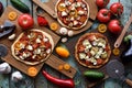 Homemade vegetarian pizza party. Flat lay of gluten free cauliflower and dough pizzas with eggplants, mushrooms, tomatoes and goat Royalty Free Stock Photo