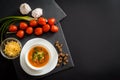 Homemade vegetarian tomato cream soup in white bowl on wooden table Royalty Free Stock Photo