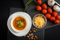 Homemade vegetarian tomato cream soup in white bowl on wooden table Royalty Free Stock Photo