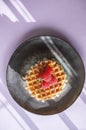 Homemade Viennese waffles with ripe raspberries on a pink background with a beautiful abstract light. Top view. copy space Royalty Free Stock Photo