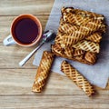 Homemade wafer rolls and cup of tea